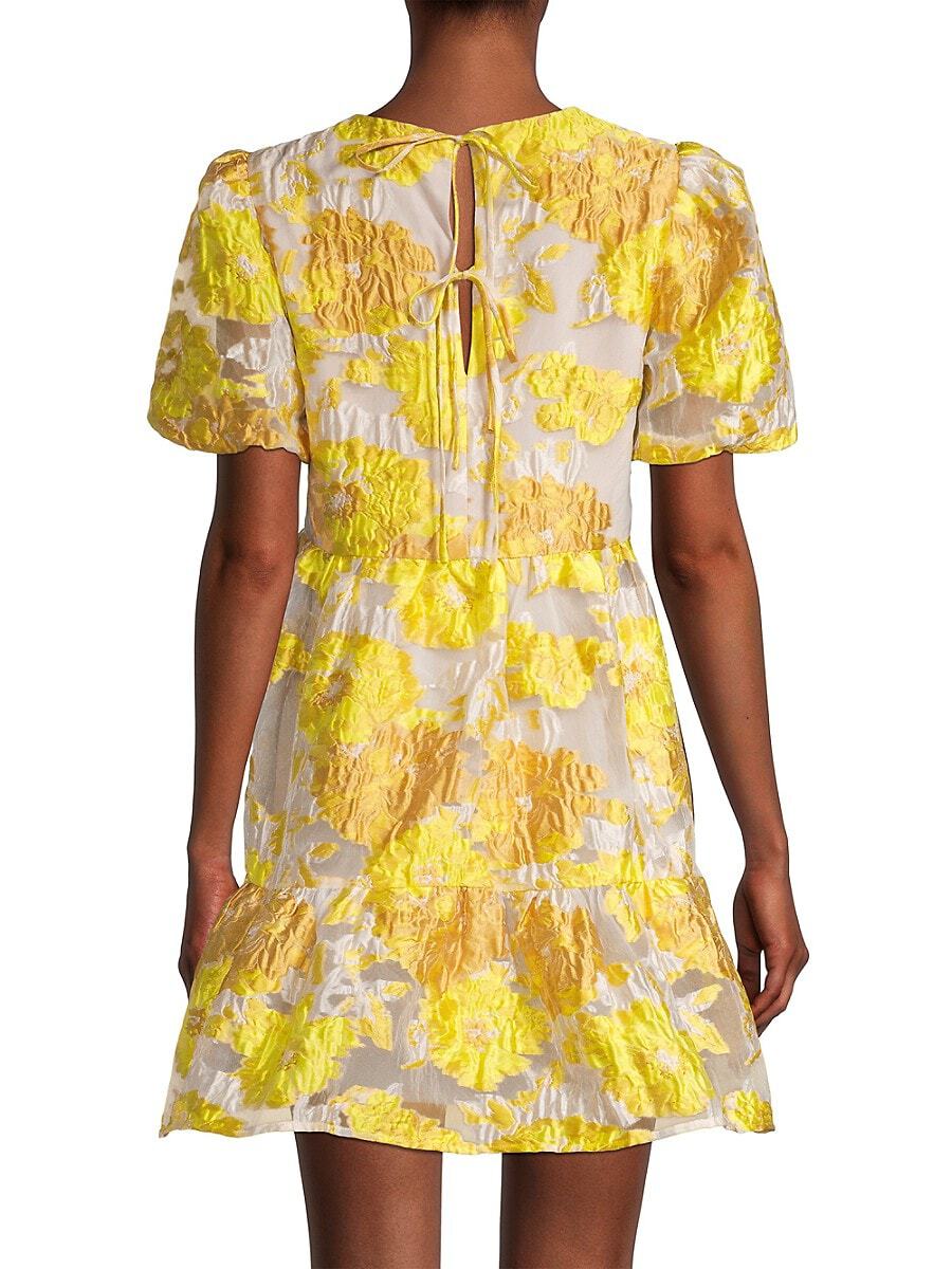 The back of a women wearing a short yellow puff sleeve dress