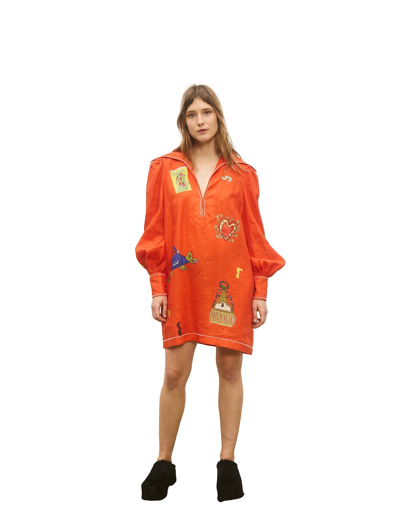 Orange dress with patches worn by a model on a white background