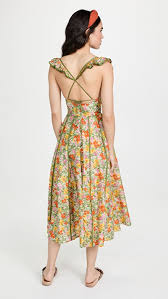 Woman wearing a long floral dress facing backwards