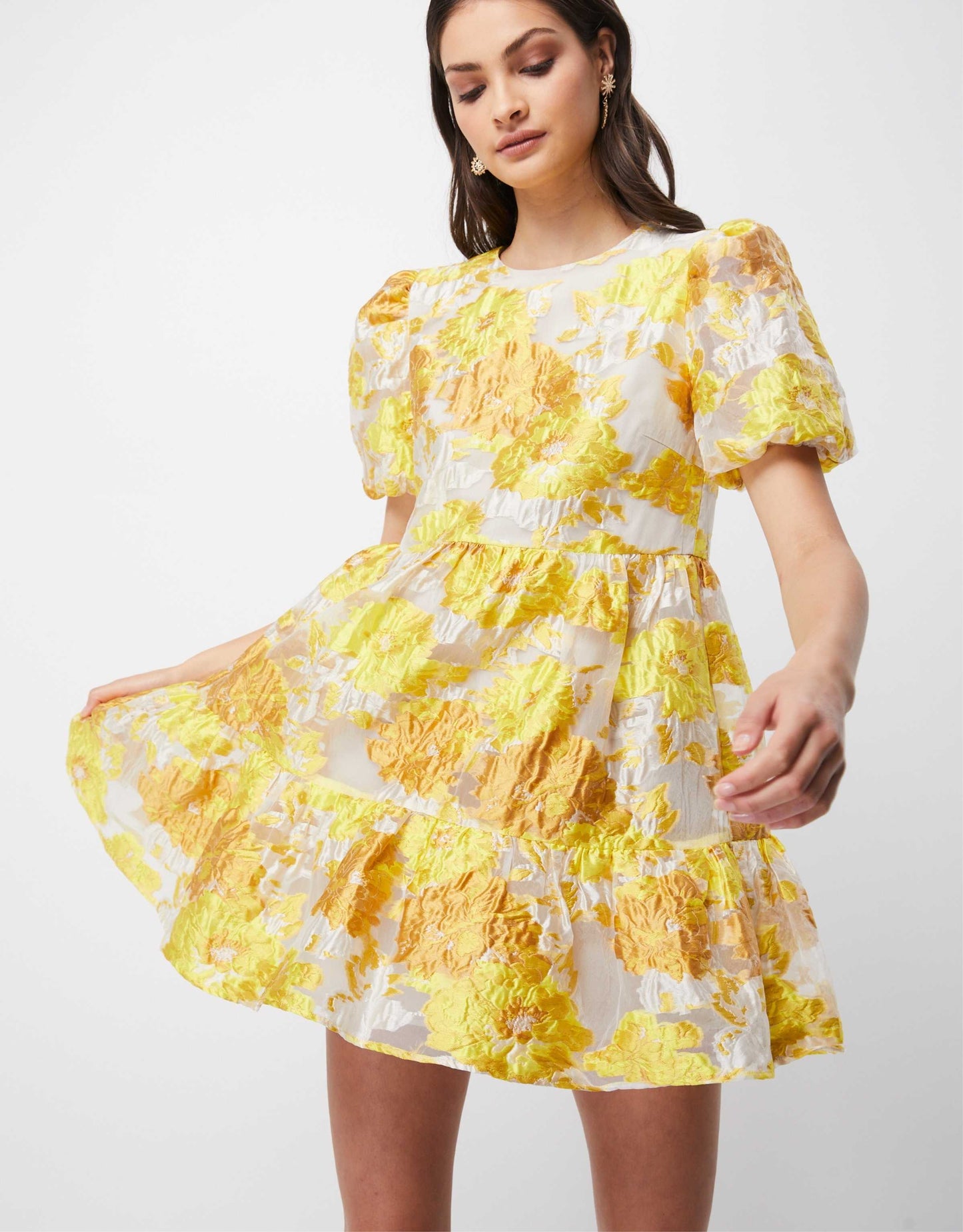 Women wearing a short yellow puff sleeve dress